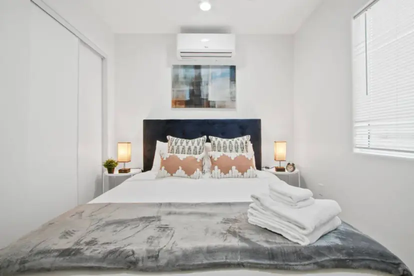 Bedroom with a navy headboard and two bedside lamps