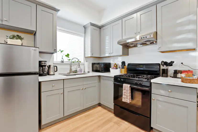 Grey shaker kitchen with a black gas range