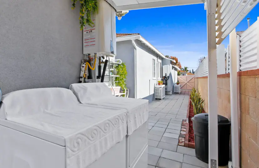 Covered side-yard laundry with a washer and dryer