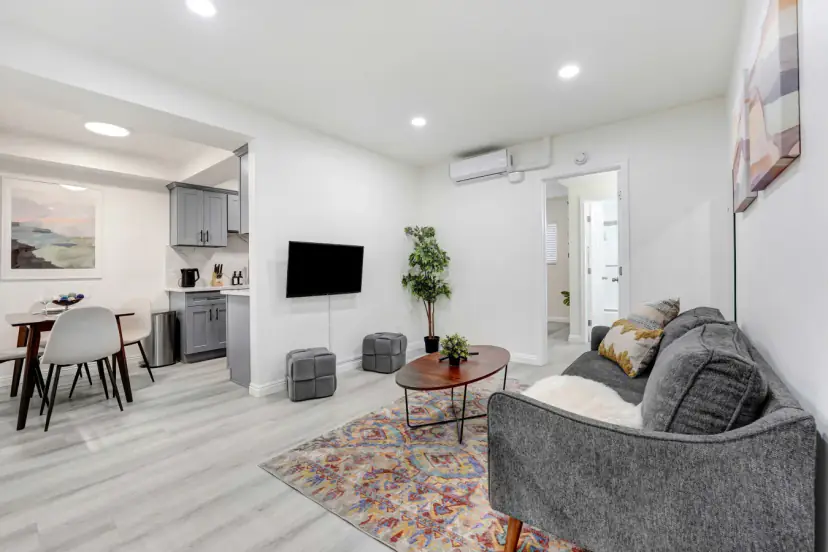 Open living room with a grey sofa and a dining table