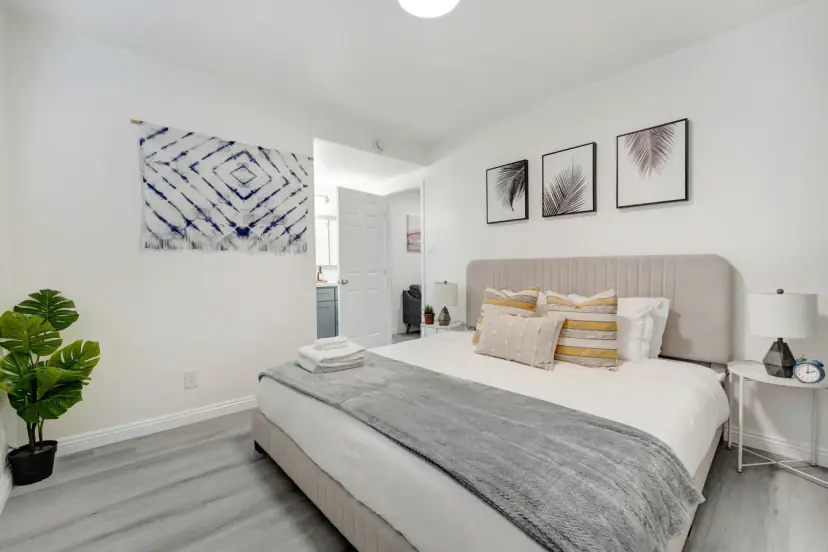 Bedroom with a king bed and framed prints