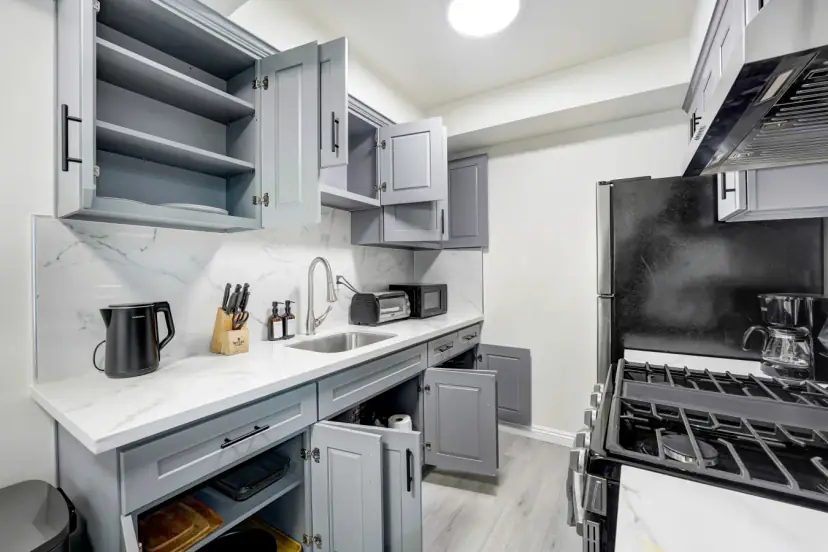 Grey shaker kitchen with a gas range