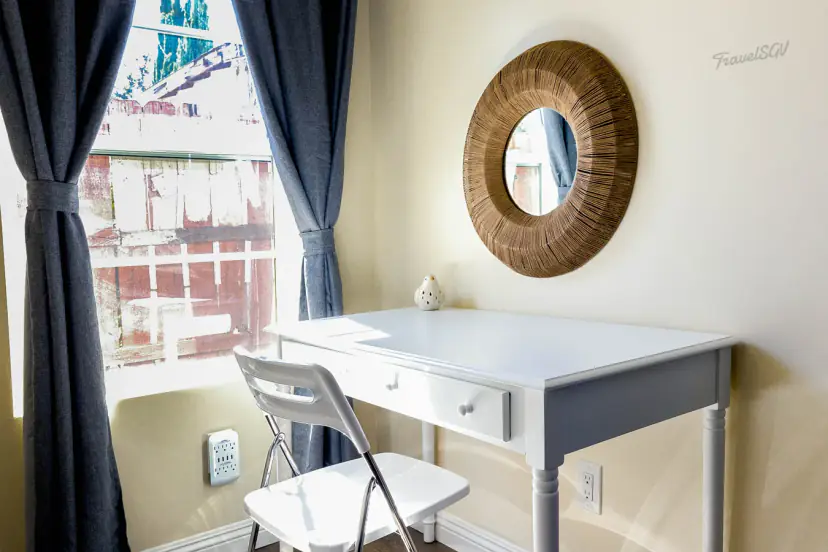 Desk with a round mirror by the window