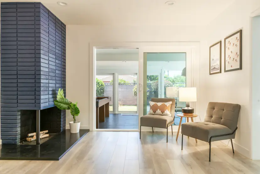 Navy brick fireplace beside two accent chairs