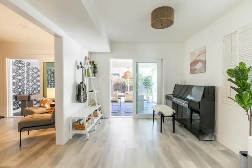 Piano nook with a wall guitar and doors to the dining room