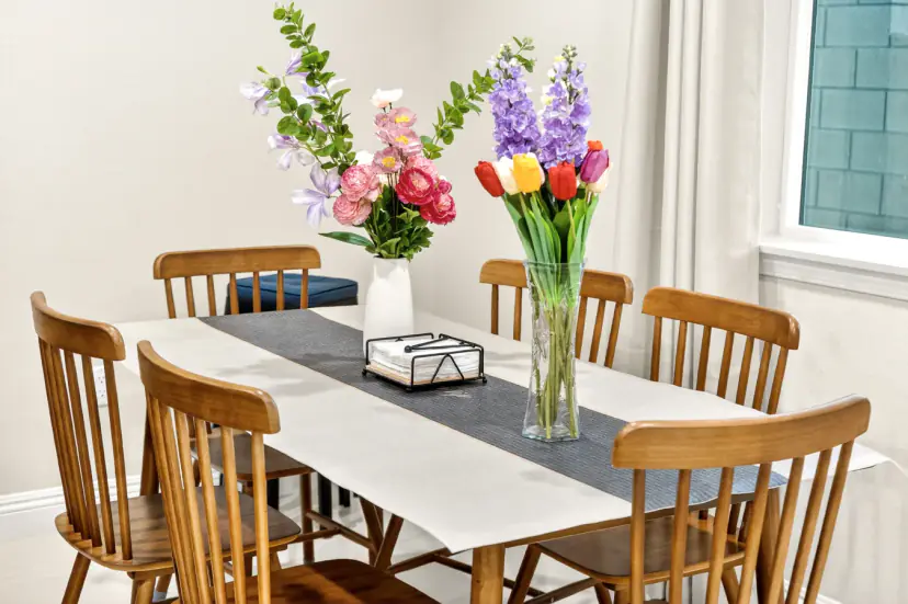 Dining table for six with wood spindle chairs and flowers