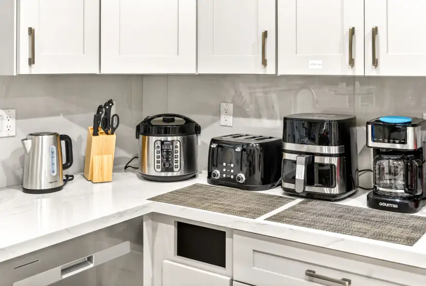 Kettle, rice cooker, toaster, air fryer and coffee maker on the counter