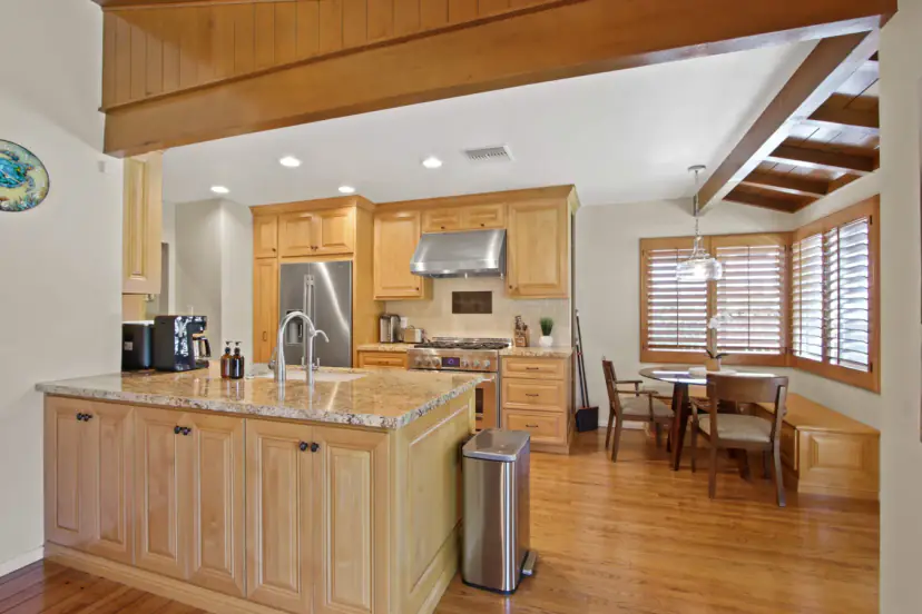 Maple kitchen with a granite island and a pro range