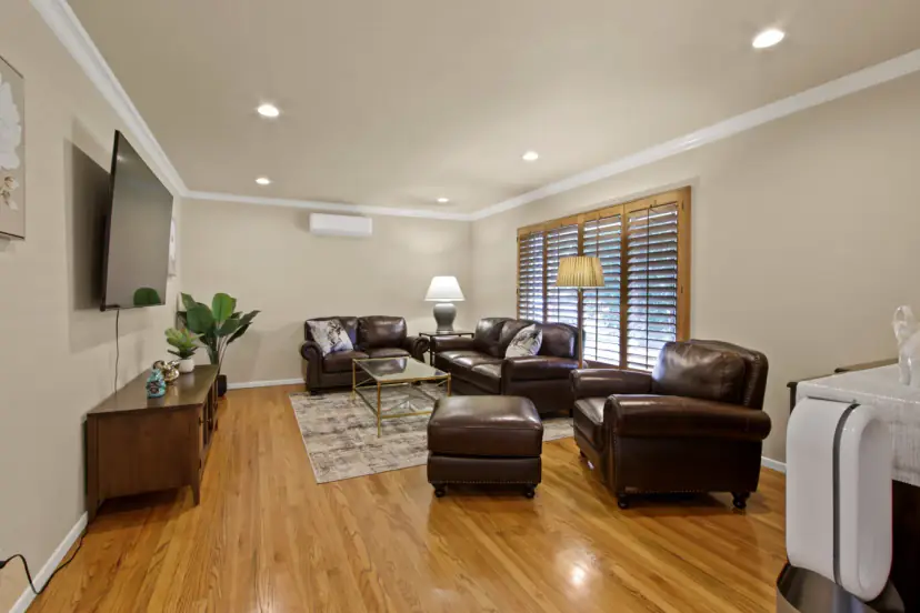 Living room with leather sofas and a wall TV