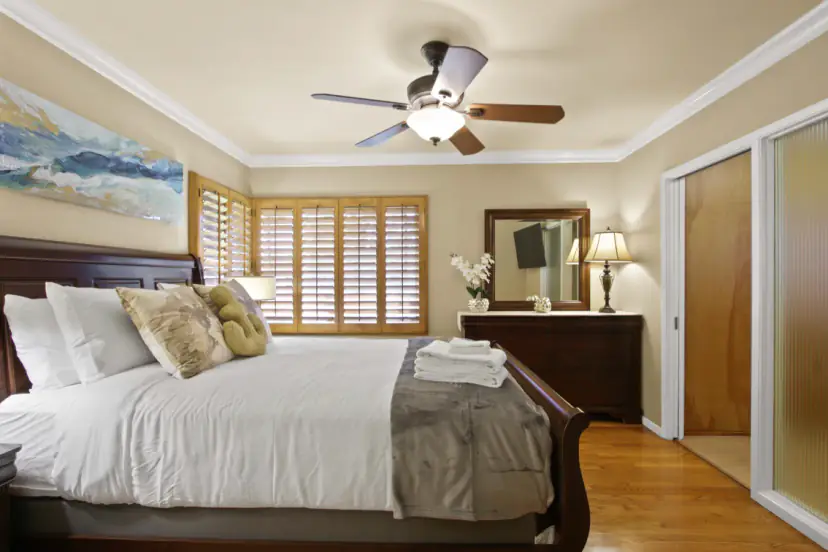 Bedroom with a sleigh bed and plantation shutters