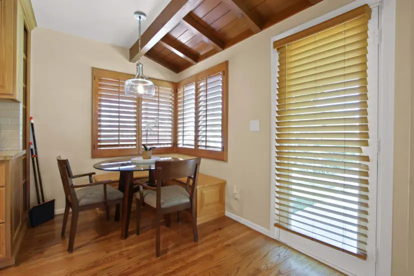 Breakfast nook with a round table and shutters