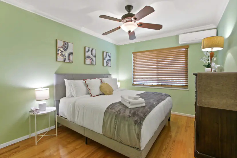 Green bedroom with a queen bed