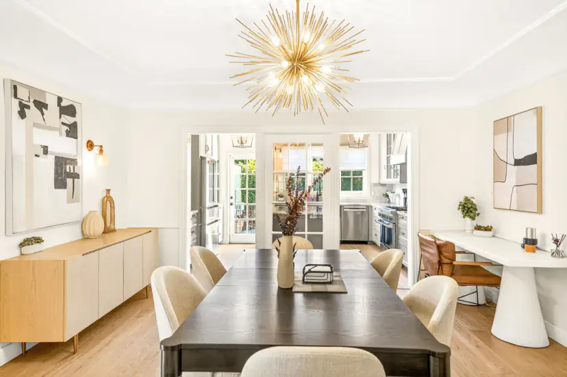 Dining table for six under a gold starburst chandelier