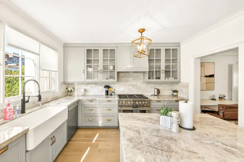 Kitchen with a farmhouse sink and a quartzite island