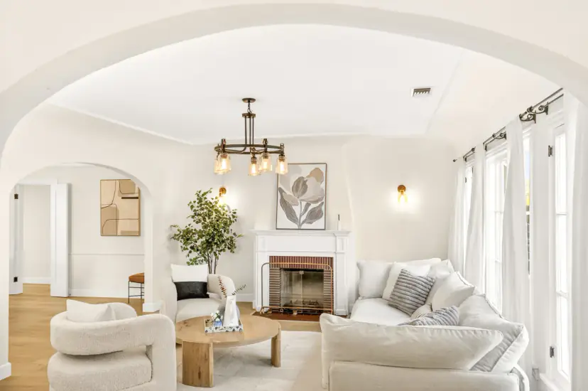 Living room through an arch with the fireplace and sectional