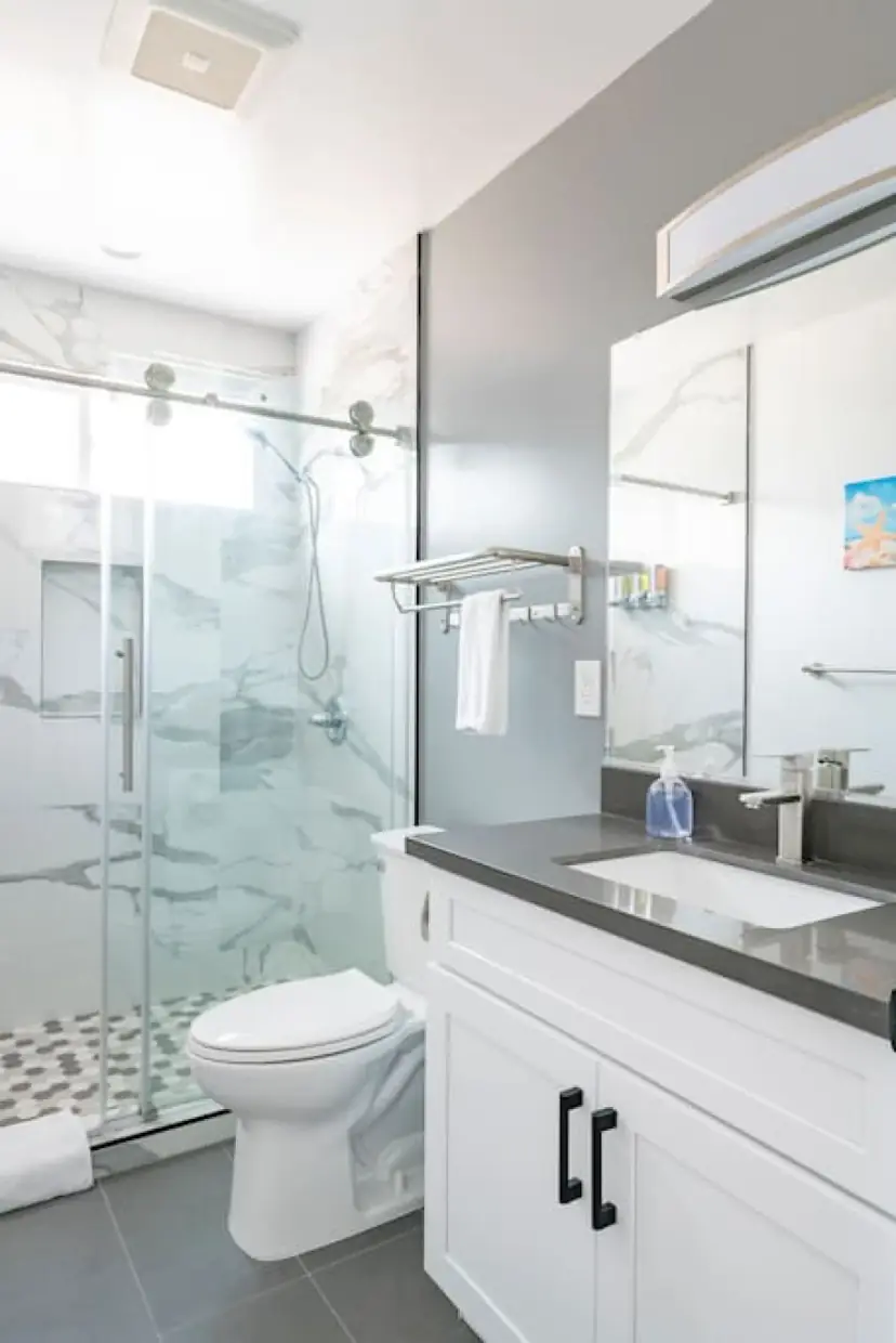 Bathroom with a glass shower and a white vanity