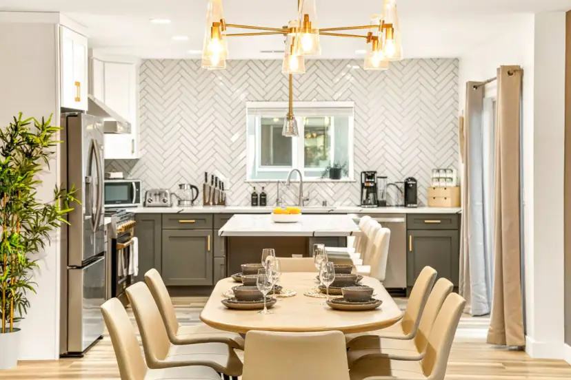 Dining table set for a group, with the kitchen behind