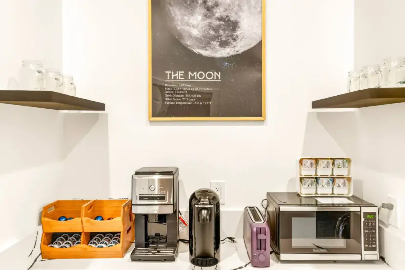 Coffee corner with a coffee maker and a framed moon print