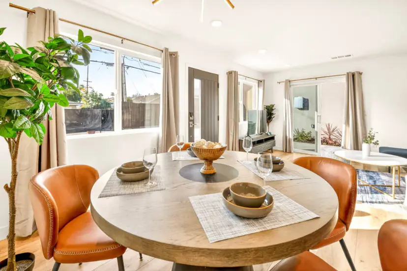 Round wood table with orange chairs