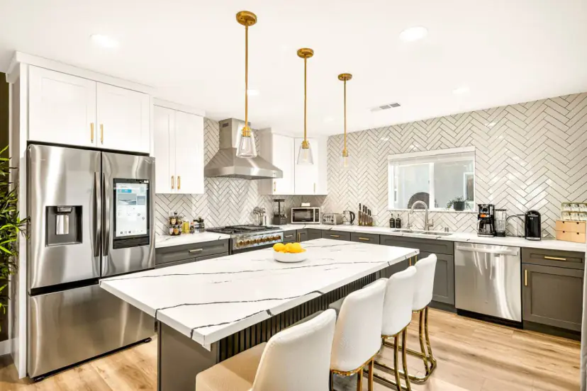 Kitchen with a marble island and four bar stools