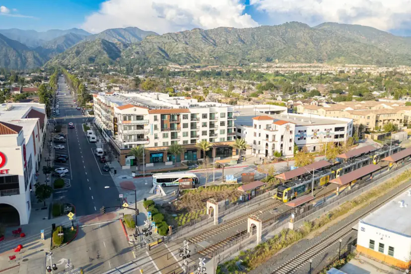 Aerial view of downtown Azusa with the Metro A Line station and the San Gabriel Mountains
