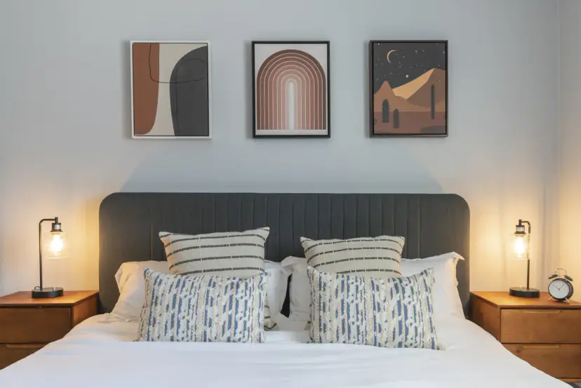 Bed with a channel headboard and desert art prints