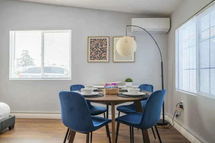 Round dining table with blue velvet chairs