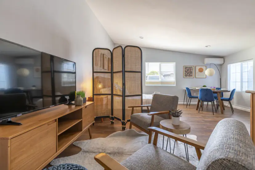 Sitting area with a TV and the dining table beyond