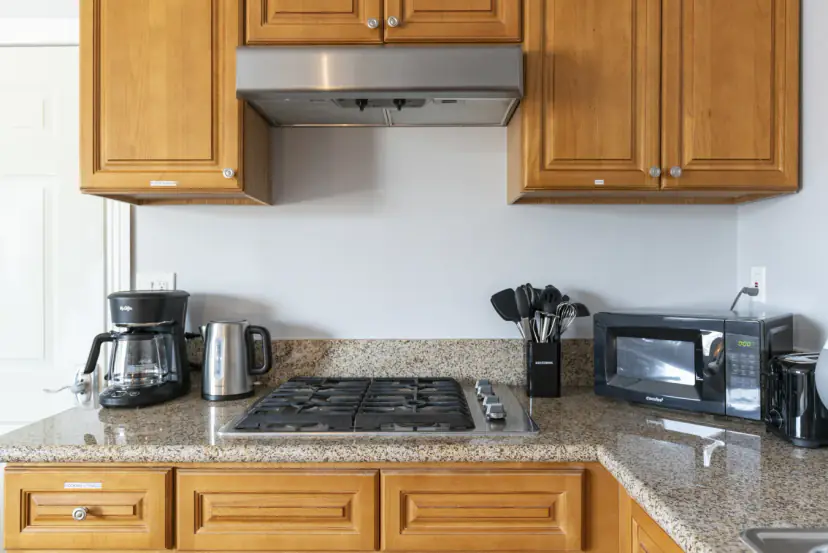 Gas cooktop with a coffee maker, kettle and microwave