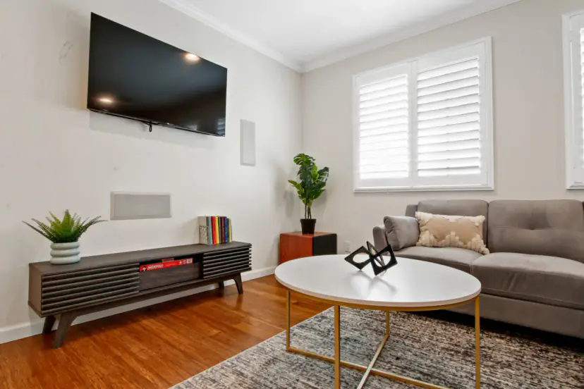 Living room with a grey sofa and plantation shutters