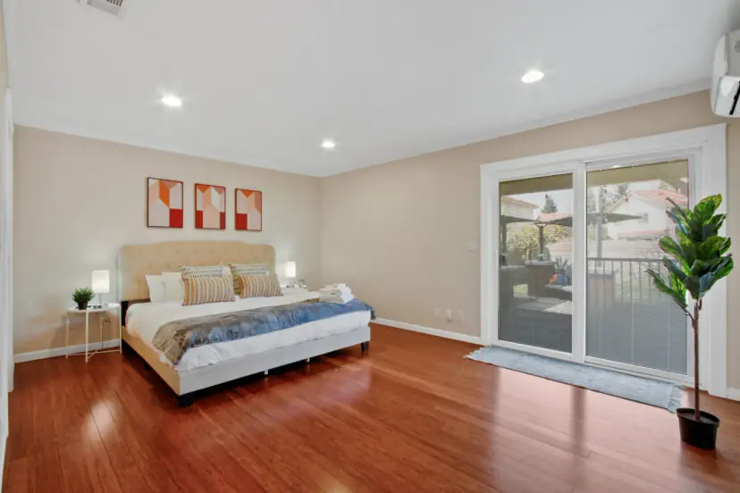 Main bedroom with a king bed and a sliding door