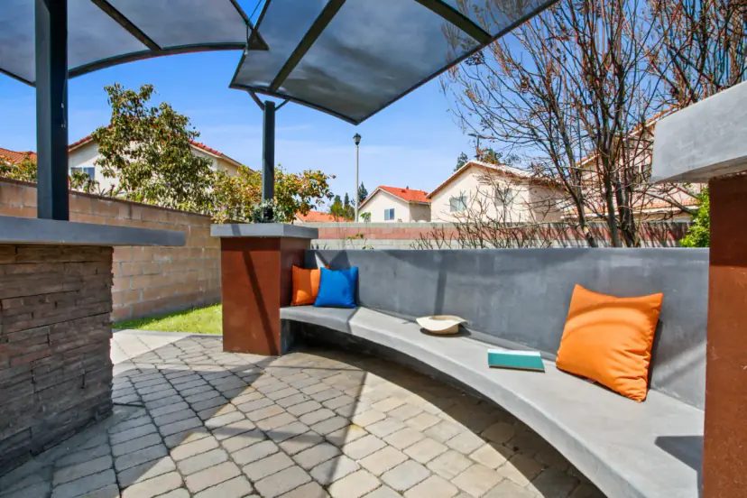 Curved bench seating with orange cushions