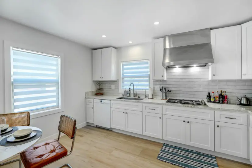 Kitchen with white cabinets, a gas cooktop and a dishwasher