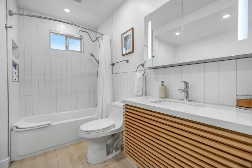 Bathroom with a wood-slat vanity and a tub-shower