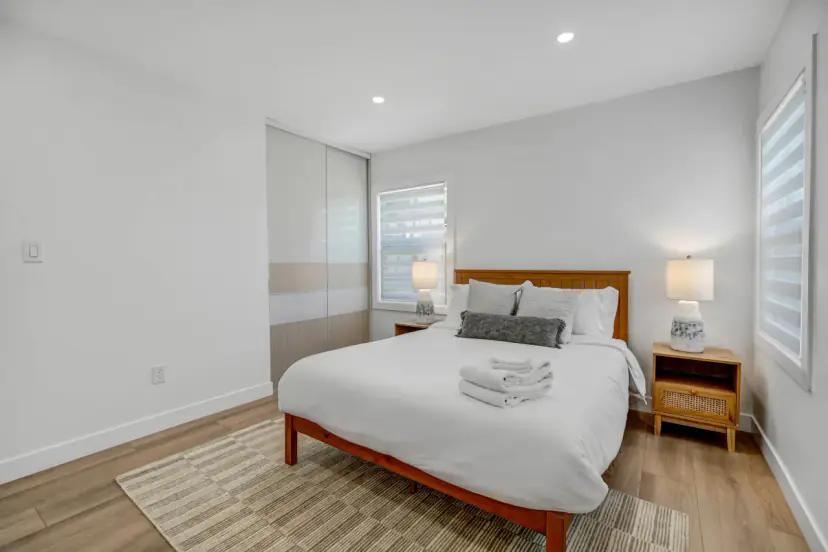 Bedroom with a wood bed and two bedside lamps