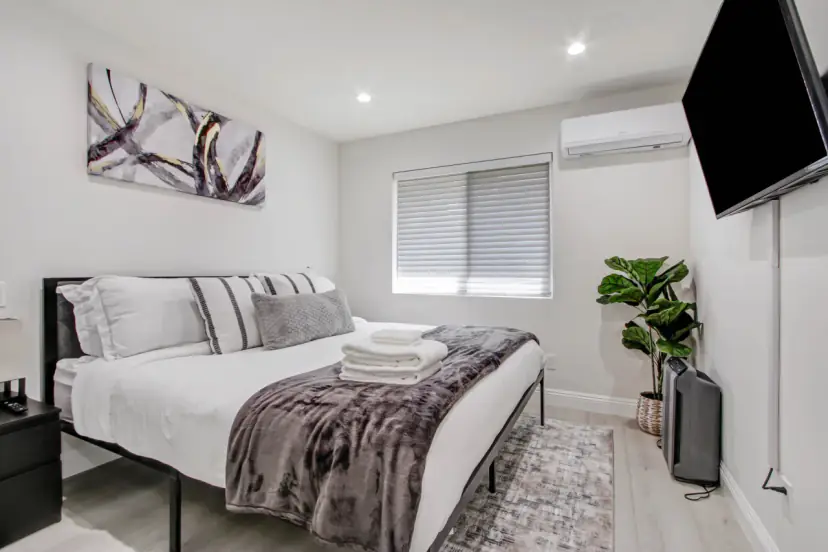 Bedroom with a king bed and a wall TV