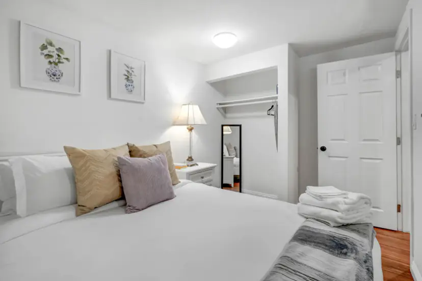 Bedroom with a queen bed and a closet