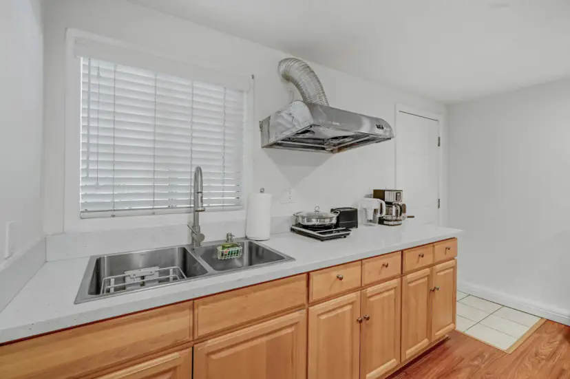 Kitchen sink and counter with a range hood