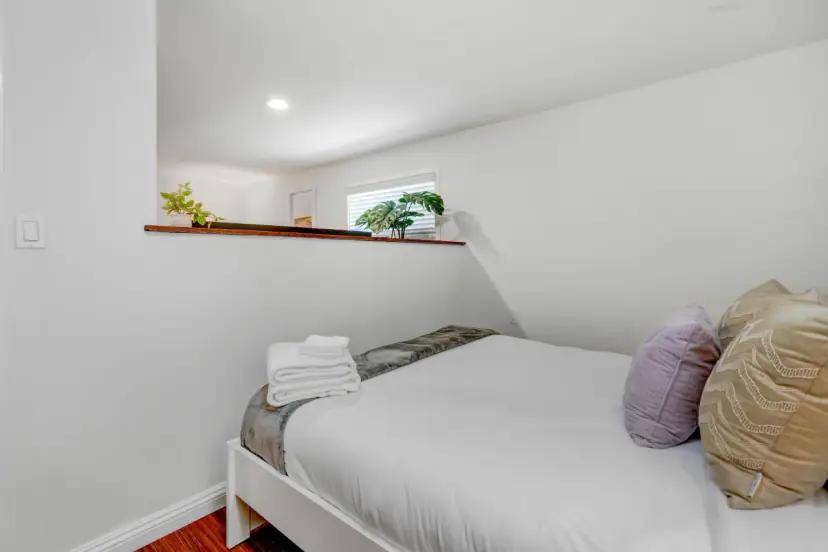 Bedroom with a queen bed and pillows