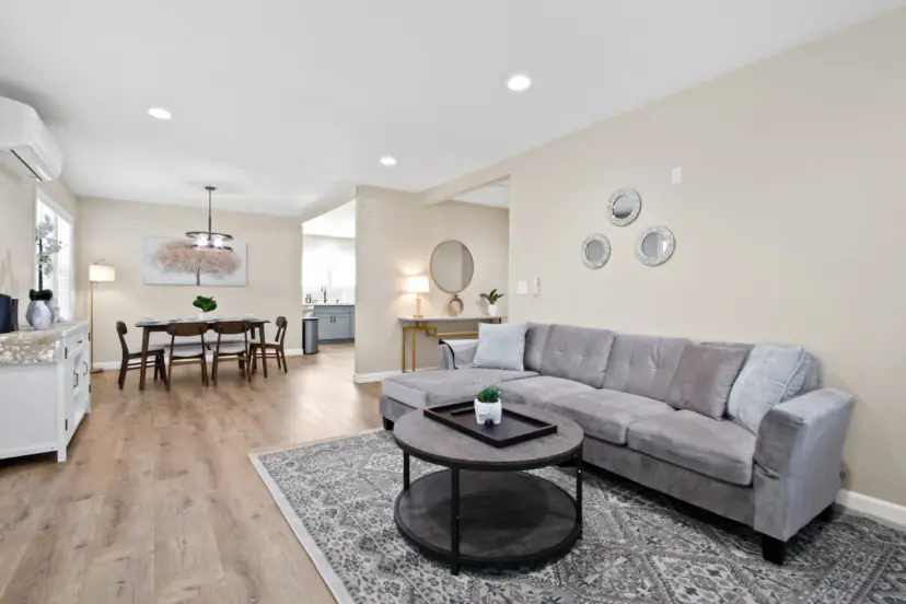 Living room with a grey sofa and the dining room beyond