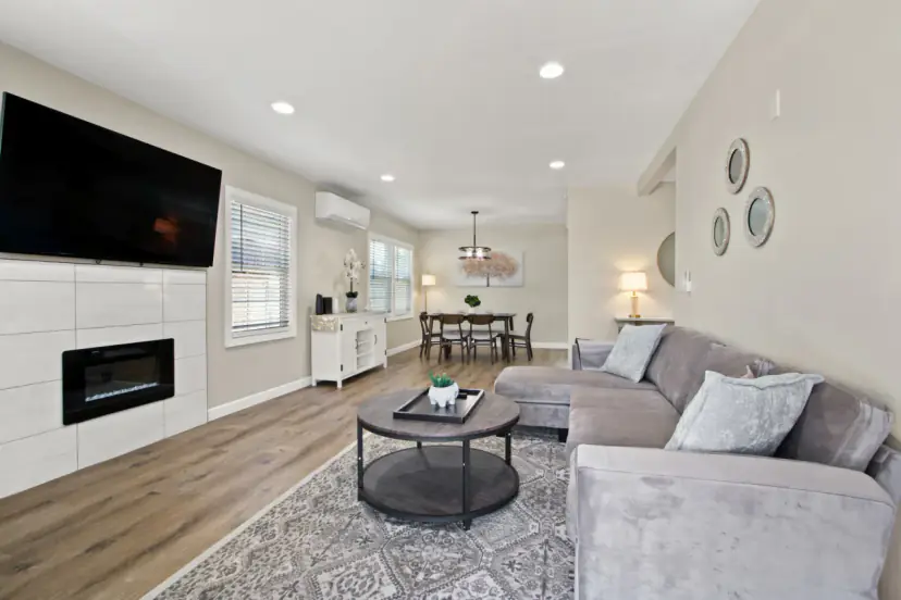 Living room with an electric fireplace and a wall TV