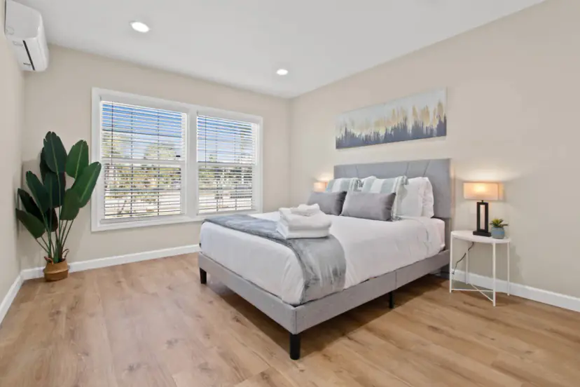 Bedroom with an upholstered bed and a large window