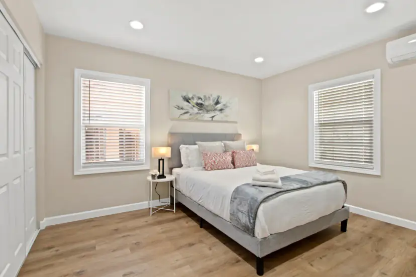 Bedroom with a queen bed and two windows