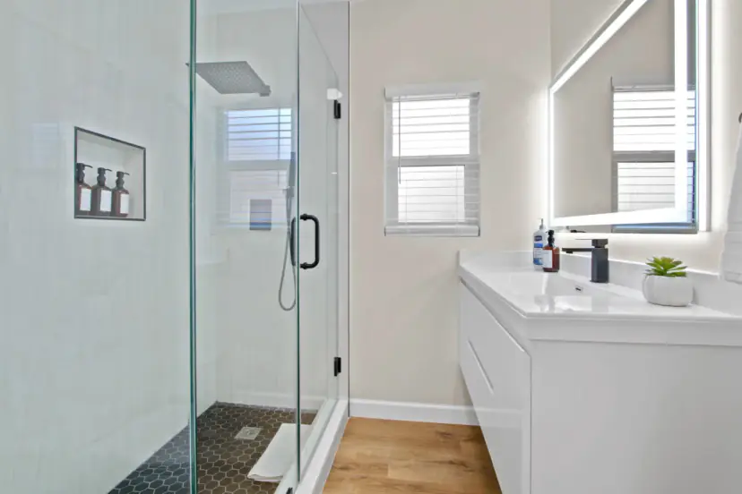 Bathroom with a frameless glass shower and a backlit mirror
