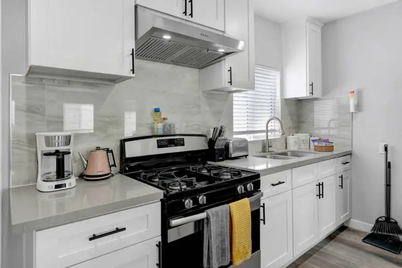 White shaker kitchen with a gas range
