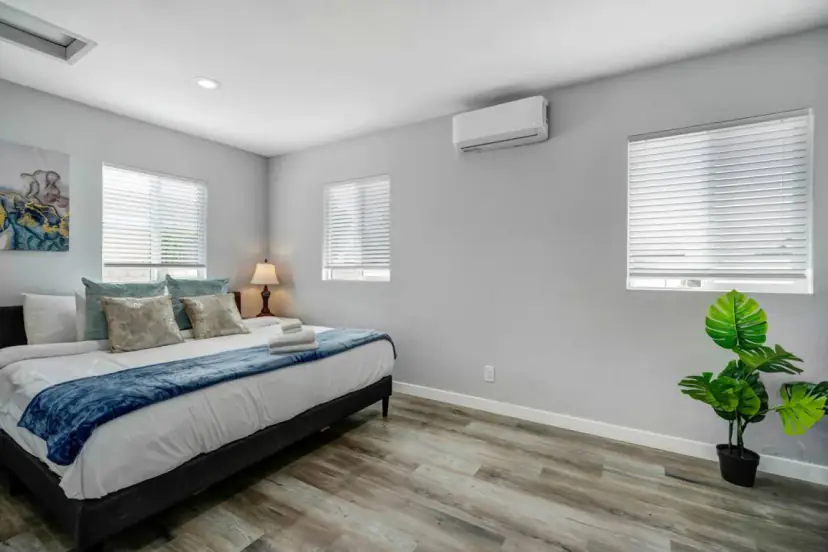 Bedroom with a king bed and a blue throw