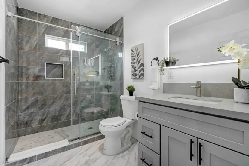 Bathroom with a glass walk-in shower and a grey vanity