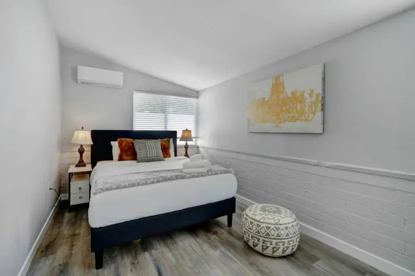Bedroom with a navy headboard and wainscoting