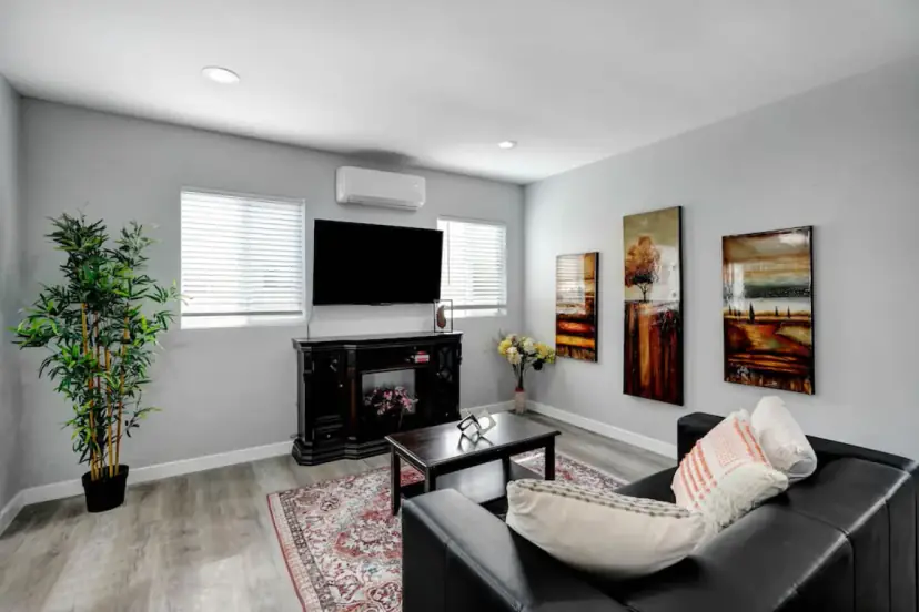 Living room with a wall TV and framed art