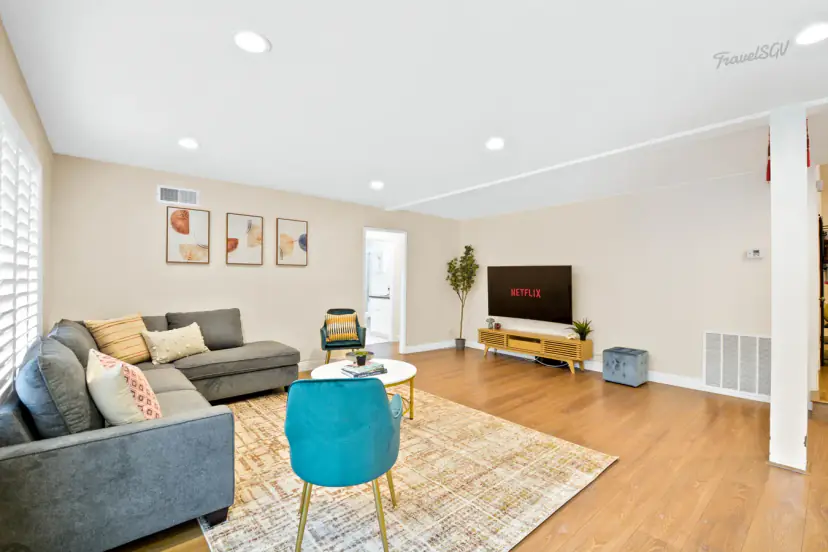 Living room with a grey sectional and teal accent chairs